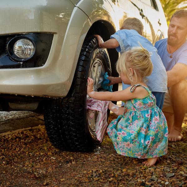 Shot of a family washing their car together.