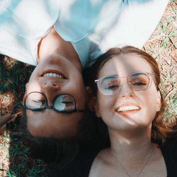 couple wearing glasses smile together