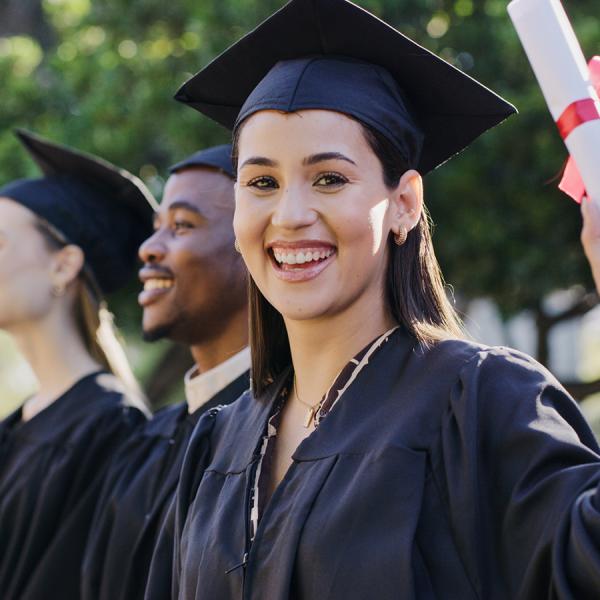 A female graduate wearing their cap and robe.