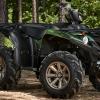 A green Yamaha XTR ATV parked amongst the trees in the woods