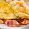 A folded egg omelet filled with chopped ham and vegetables.